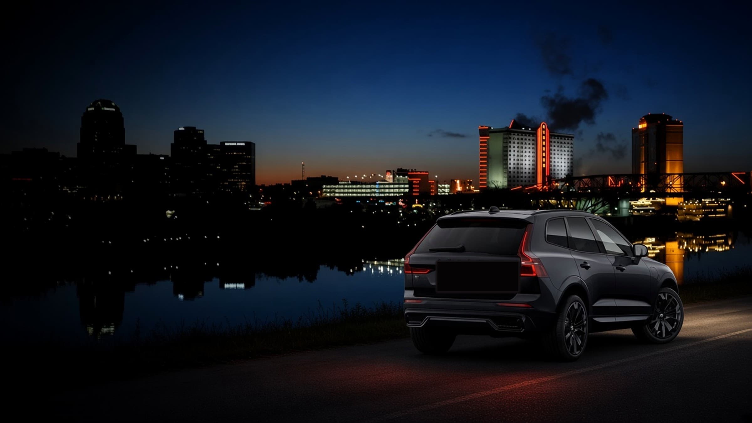 Spainhour Bail Bonds mobile service — dark SUV with red taillights against the Shreveport-Bossier nighttime skyline