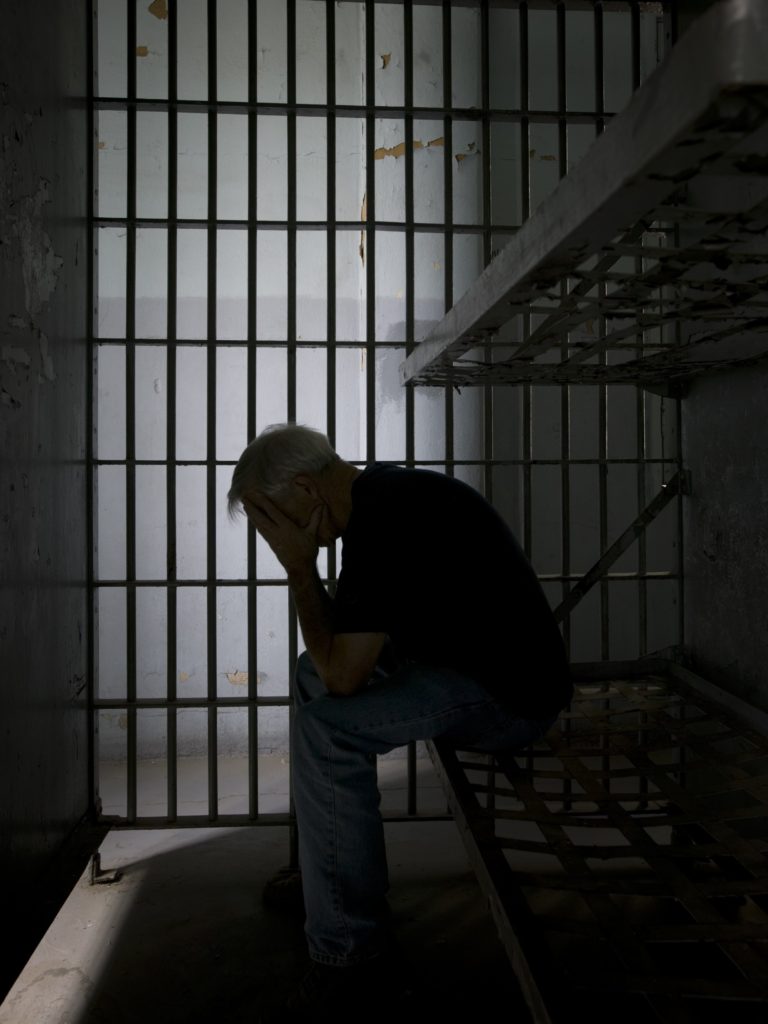Man in jail cell - spainhour bail bond
